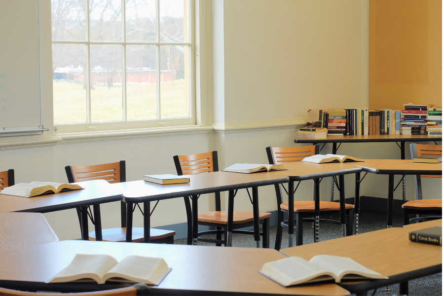 A demo class room set up for the open house. The tables are arranged in a circle to promote discussion and the Socratic method. 