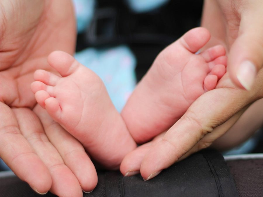 Newborn baby feet & mother